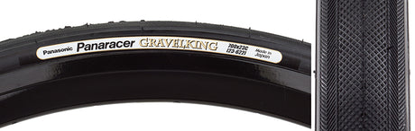 Close-up of a 700x23 Black/Black Gravel King Slick Bicycle Tire, featuring minimal tread and robust volume for versatile use on roads and gravel, with a white label visible on the tire.