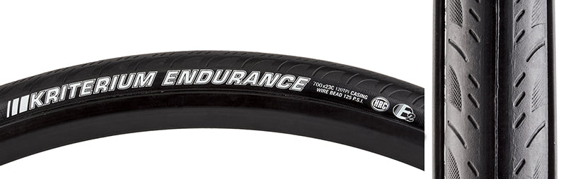 Close-up of the 700x23 Kriterium Enduro Pro Bicycle Tire, showcasing its grooved side tread and white text, designed for durability and traction with dual-layer puncture protection and 120tpi casing.