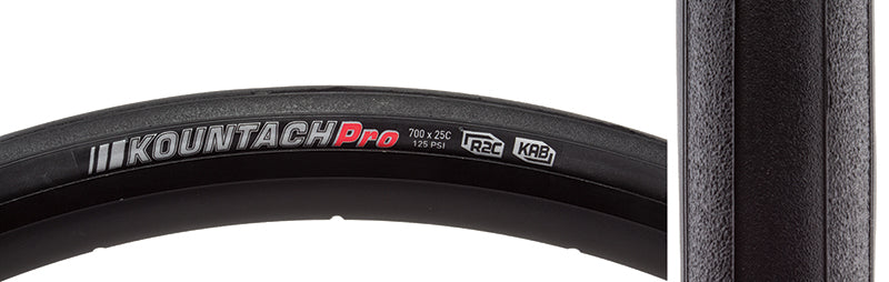 Close-up of the 700x25 Reflective Kountach Pro Bicycle Tire showcasing its smooth center tread, textured shoulders, and reflective sidewall striping designed for enhanced traction, speed, and low-light visibility.