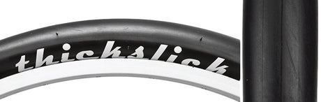 Close-up of the 700x28 ThickSlick Comp Bicycle Tire showcasing its extra thick slick tread, designed for puncture resistance and durability, ideal for fixie riders.