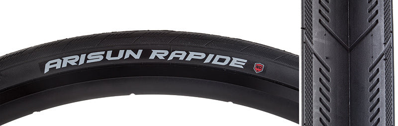 Close-up of the 700x32 Rapide Wire Bicycle Tire showcasing its directional arrow tread design with knurled shoulder tread and inverted patterns, emphasizing its advanced traction and puncture resistance features.