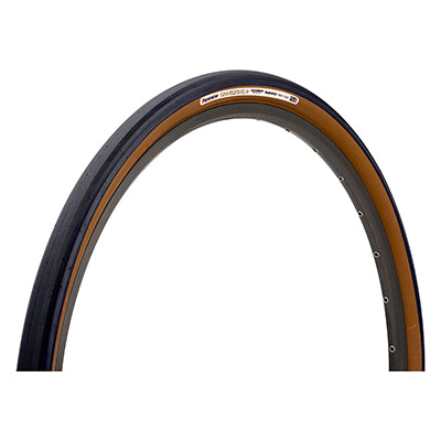 Close-up of a 700x32 Black/Brown Gravel King+ Slick Bicycle Tire, showcasing its minimal tread design and robust volume, ideal for versatile terrain and weather conditions, featuring superior grip and puncture protection.