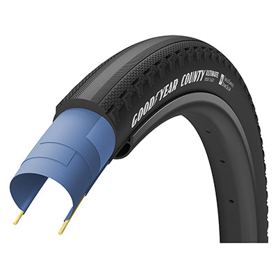 Close-up of the 700x35 Country S4 Ultimate Bicycle Tire highlighting its widely-spaced side knobs and smooth center tread designed for optimal grip and rolling efficiency on varied terrains.