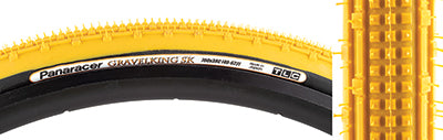 Close-up of a 700x38 Mustard/Black Gravel King SK Bicycle Tire highlighting its square knobs and continuous ridges designed for smooth rolling and grip on rough or gravel roads.