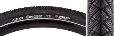 Close-up of the 700x42 Reflective Crucible Bicycle Tire, highlighting its tread pattern and reflective sidewall designed for night visibility. The tire features Kevlar Inside puncture protection and optimized longevity.