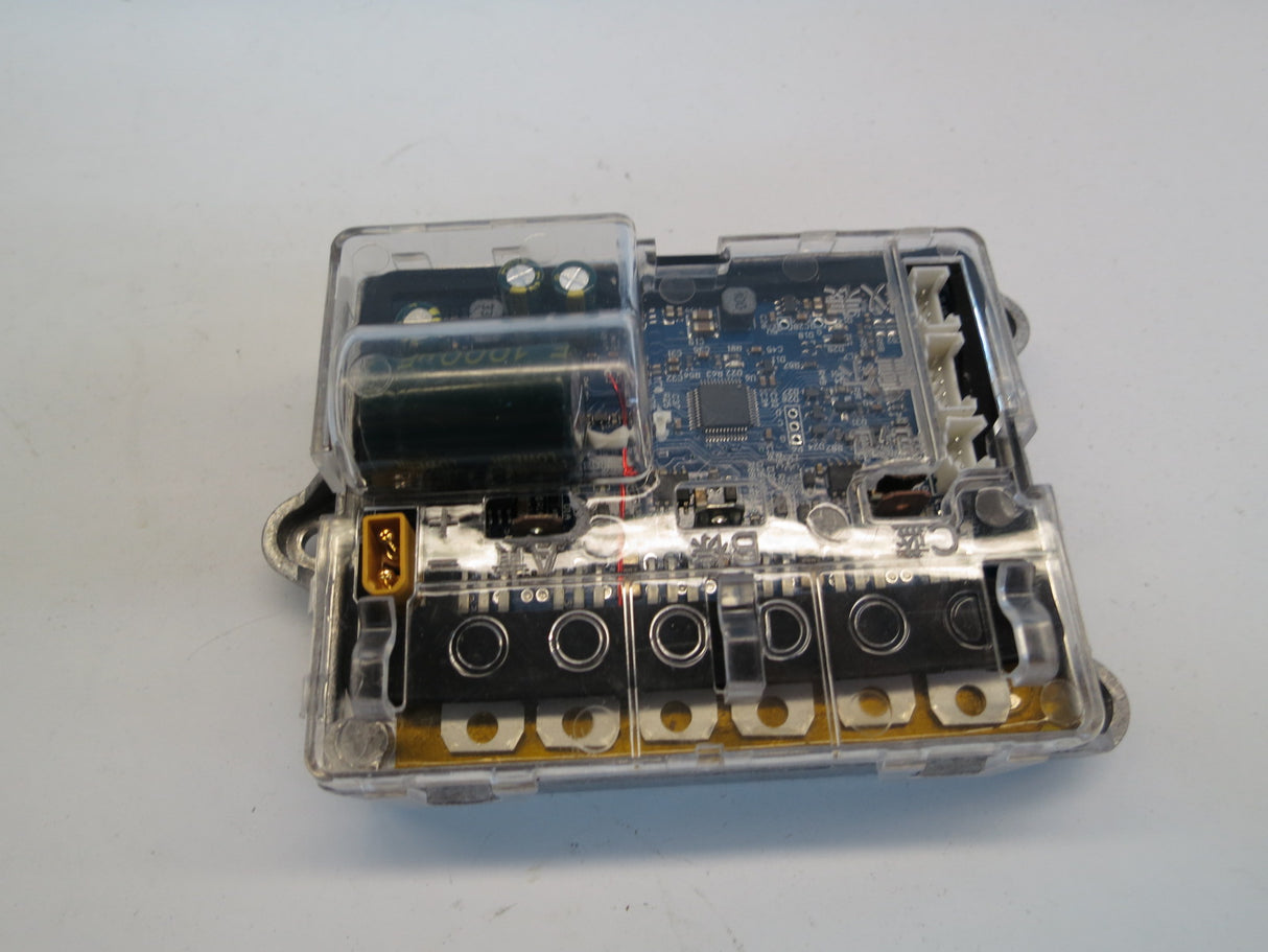 Bluetooth Board, Motherboard, & Harness for Xiaomi Mi M365, shown inside a transparent plastic box with visible circuit board and wiring, crucial for the scooter's console and battery tray operations.