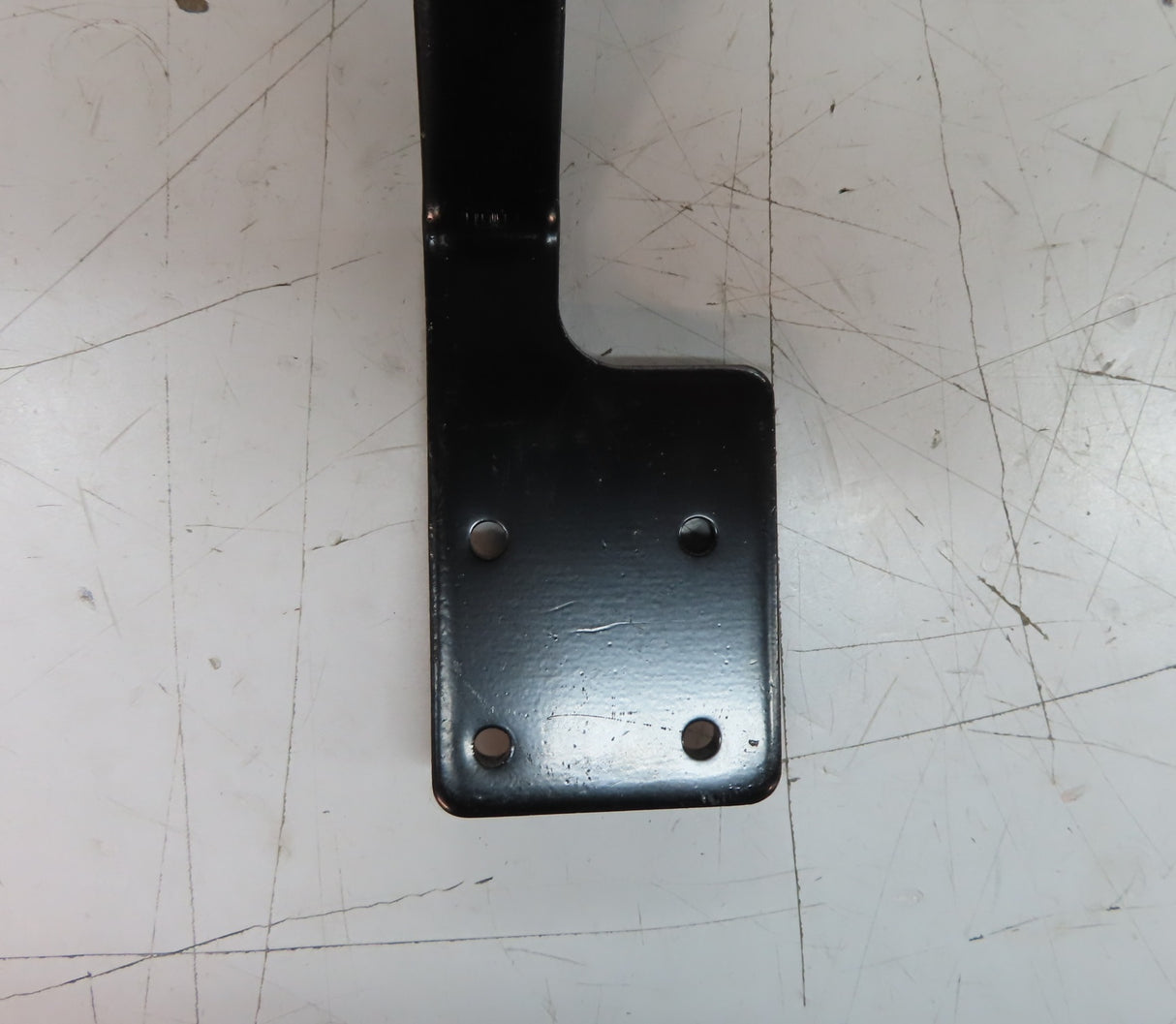 Inline Joystick Mounting Bracket for the Dynamic Shark Remote, black metal with pre-drilled holes, designed for Jazzy power chairs, shown on a white surface.