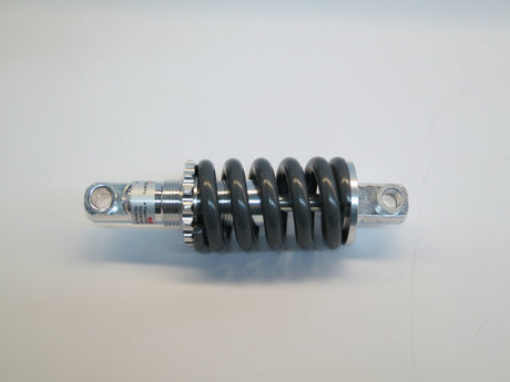 Front Strut Shock for the Quantum Q6 Edge, shown in close-up, highlighting its black and silver metal coil and strut structure, compatible with standard Q6's front caster arm assembly, excluding vent tray models.