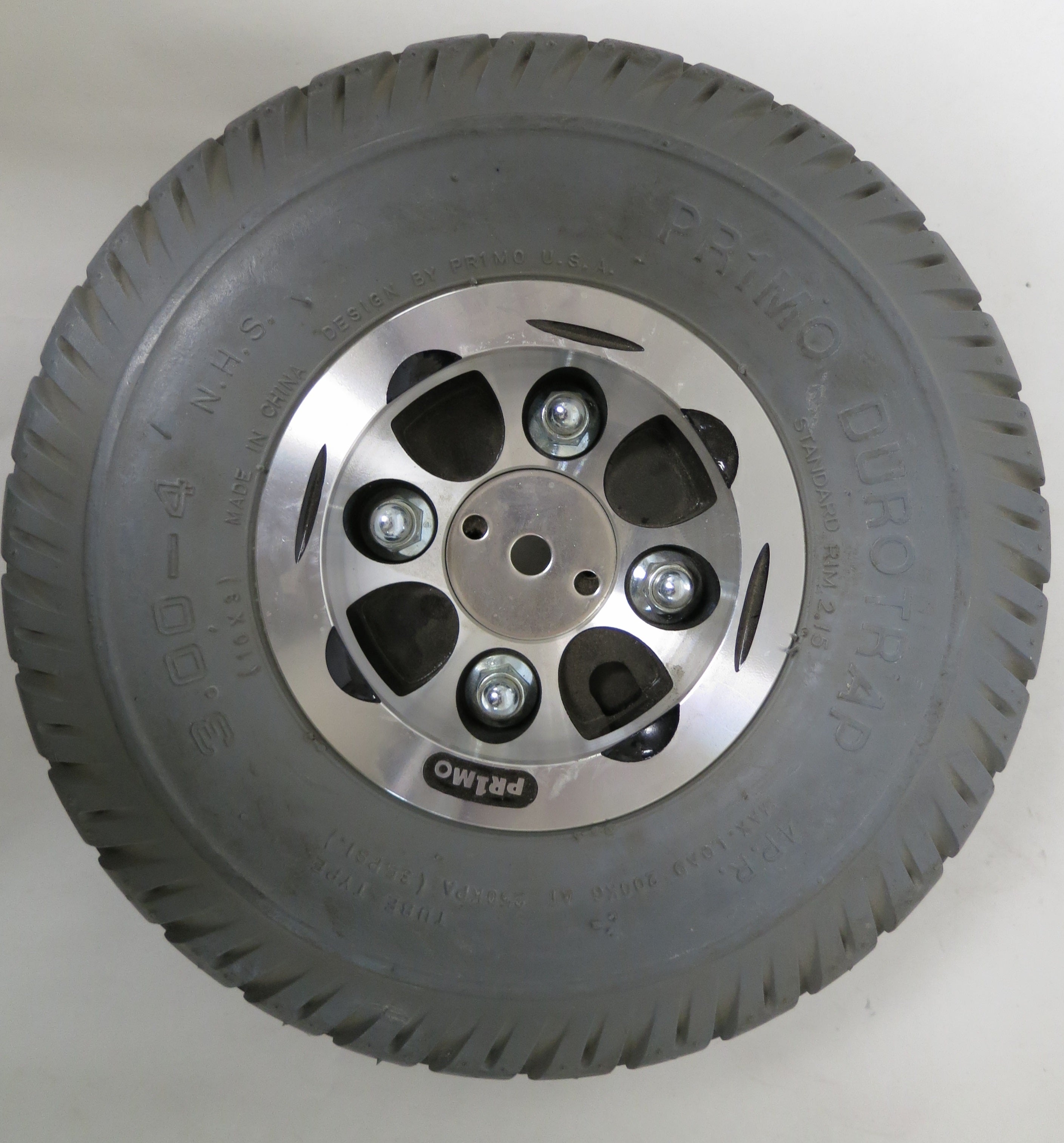 Close-up of a 3.00-4 (10x3, 260X85) foam-filled drive wheel assembly with a silver rim, designed for the Shoprider Streamer Sport (888WA), featuring a detailed view of the tread and rim.