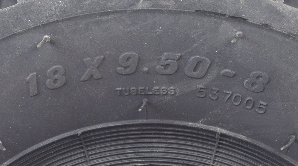 Close-up of a Carlisle 18X9.50-8 Knobby Tire, showcasing its aggressive tread pattern designed for superior grip on off-road terrains, ideal for ATVs, go-karts, and utility vehicles.