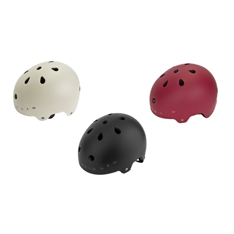 Skid Lid Pro 2 Bike & Scooter Helmet with ventilation holes, shown in a group of matte-finish helmets including black, white, and red. Suitable for biking, scootering, boarding, and skating.