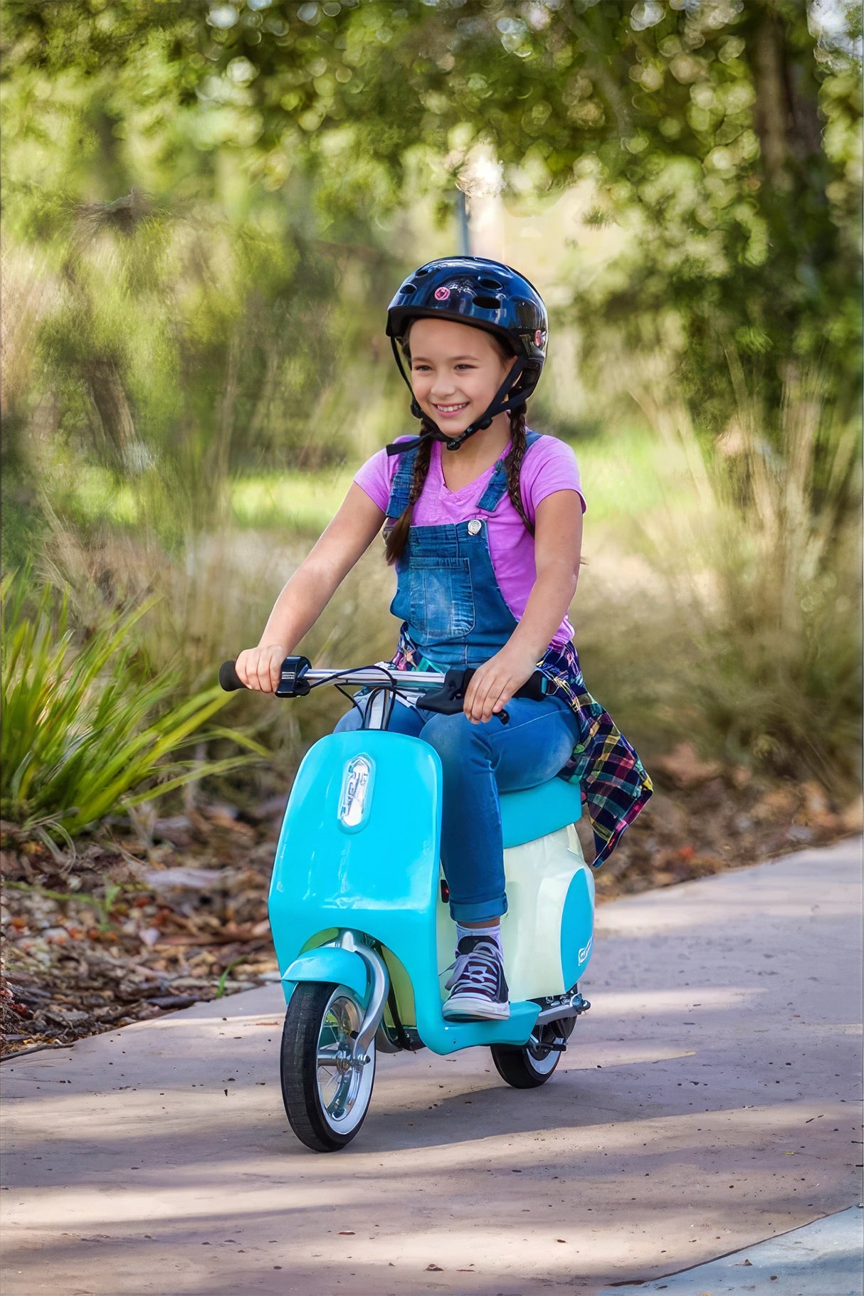 Girl riding a scooter, highlighting the 24 Volt 250 Watt MY1016 Electric Motor with 11 Tooth #25 Chain Sprocket (Blemished) on the scooter's wheel.