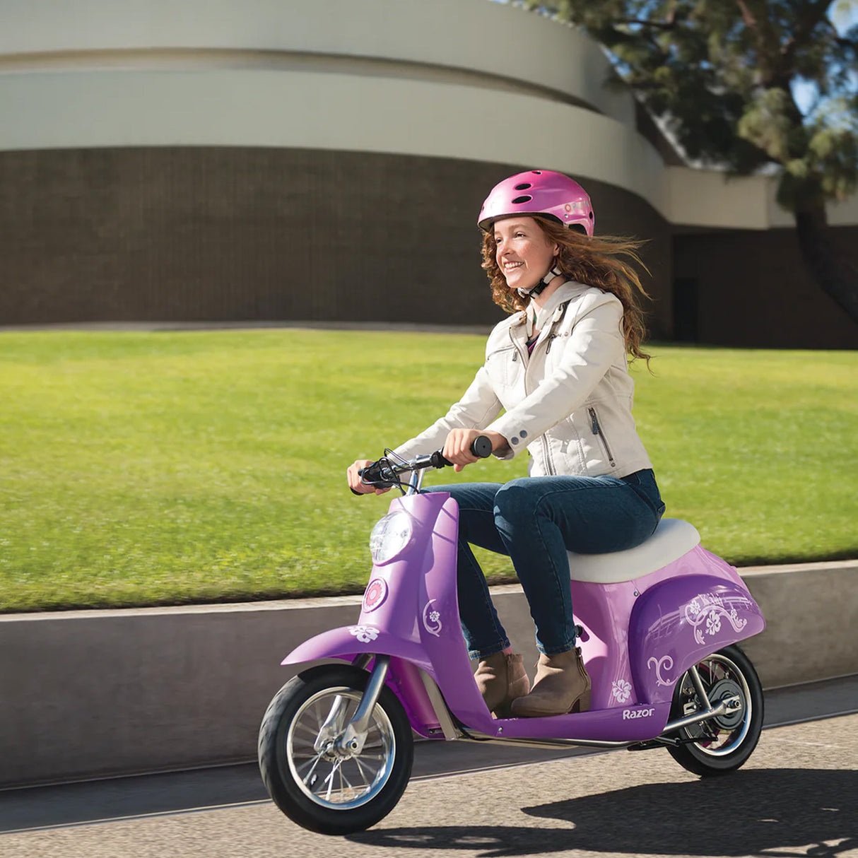 Woman riding a purple scooter, showcasing the 12-1/2 x 2-1/4 Razor Pocket Mod Inner Tube, ideal for fixing flat tires on all Pocket Mod models, including Bella, Betty, and more.