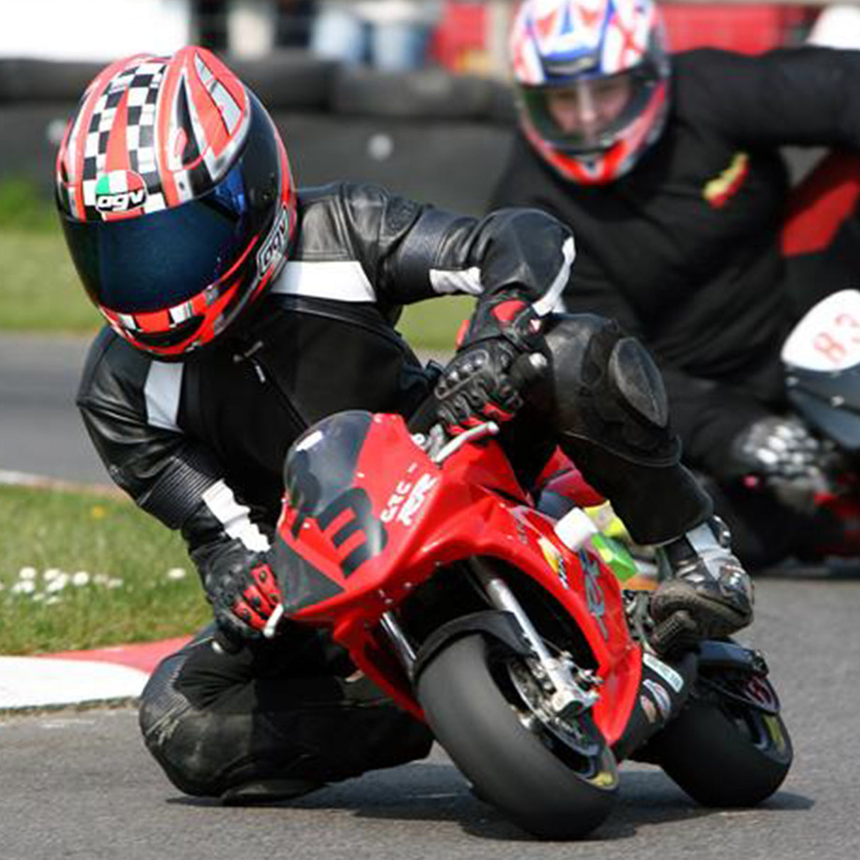 18 Volt Battery for Minimoto Sport Racer (Blemished) shown with a group of motorcyclists racing, highlighting the battery's relevance for deep discharge applications in motorcycle racing.