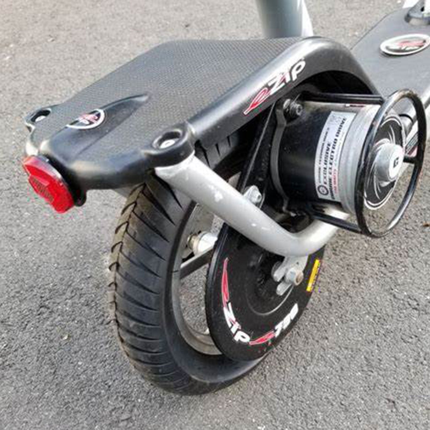 12-1/2x3.0 Tire with V-Groove Street Tread for the Schwinn S500 Scooter featuring shallow grooves for grip on hard-paved surfaces, shown on a black scooter with a black wheel.