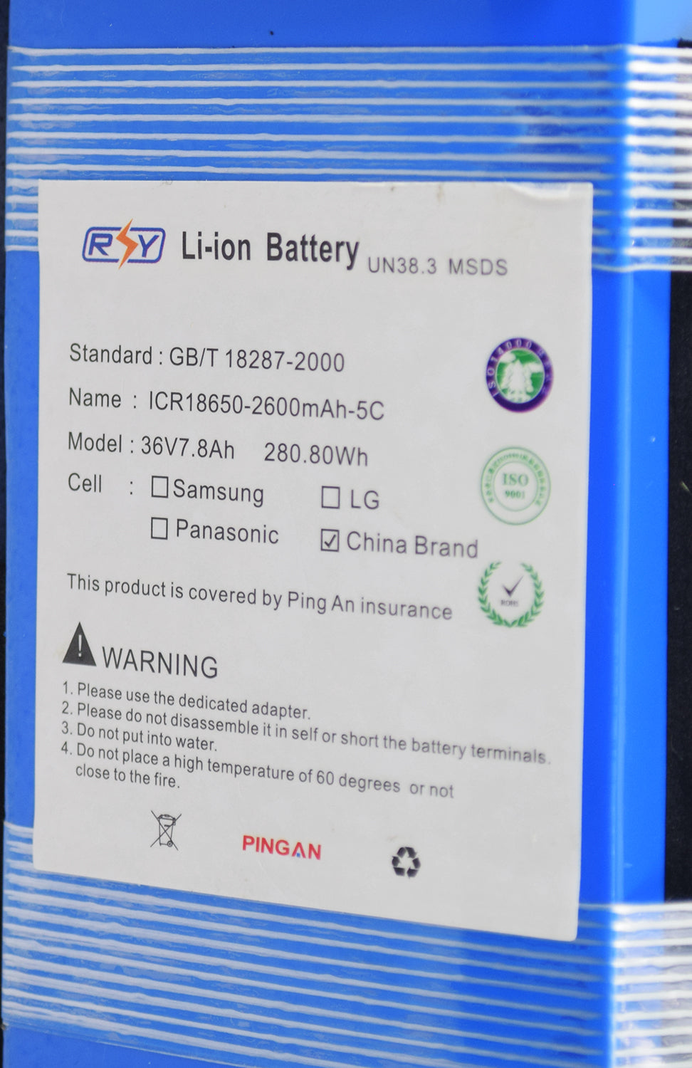 Close-up of the 36 Volt 7.8 Ah Lithium-ion Battery Pack for the Swagtron EB5 Folding Electric Bike, featuring visible labels, logos, a black recycle symbol, and a black triangle with a white exclamation mark.