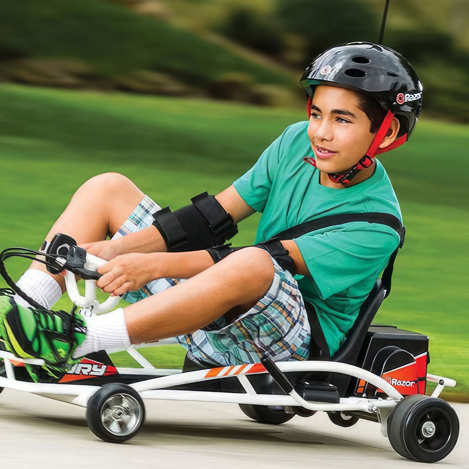 Set of 2 Super Slider POM Rear Wheels for the Razor Ground Force Drifter (Blemished), shown mounted on a go-kart driven by a boy wearing a helmet, highlighting their functionality.