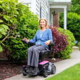 Woman sitting on a motorized scooter, showcasing Black Vinyl Co-Molded Full Length Armrest Pads for Jazzy Power Chairs & Pride Mobility Scooters (Set of 2).