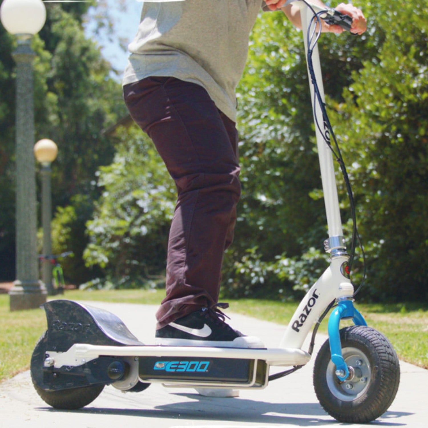 ZK2430D-FS Control Module with 4-Wire Throttle Connector for the Razor E300 (Versions 20+), shown installed on a scooter with visible close-up of a wheel and a person's foot riding.