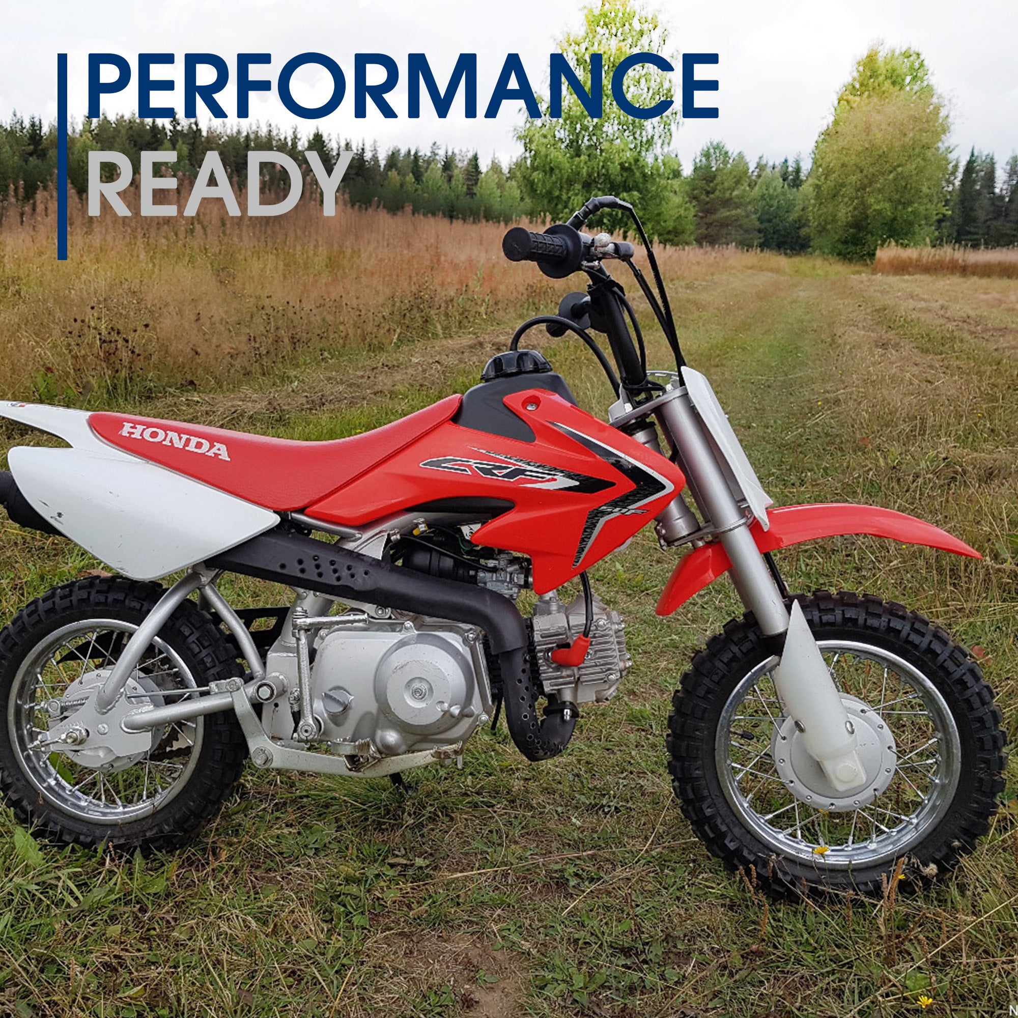 2.50-10 Dirt Bike Tire for MotoTec Demon & MT-Dirt-500 Dirt Bikes, showcasing a durable directional knobby tread pattern, mounted on a red and white dirt bike parked on grass.