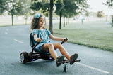 Young girl riding a scooter outdoors. Product title: Front Caster for Hoverboard Go-Kart Kit. The caster is attached to a hoverboard go-kart frame, showing its functionality and design.