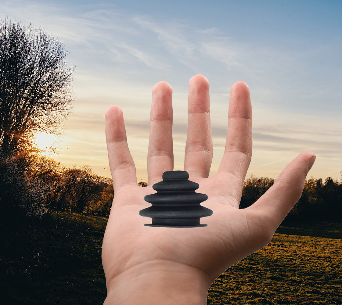 Joystick Rubber Boot for PG Drives Joystick Controllers (VSI, VR2, GC, and Remote Plus) shown held in a person's hand, illustrating the OEM replacement part's size and shape.