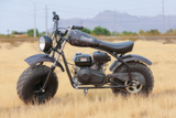 Seat for the Coleman CT200U-EX Mini Bike shown mounted on a motorcycle parked in a field, emphasizing the replacement seat's fit and appearance.