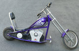 Purple motorcycle on pavement, showcasing the 201C6-3A / HB2430TYD-FS Razor 6-Wire Throttle & Controller Bundle for the Razor Mini Chopper, all versions, with a close-up of the wheel and motorcycle tank.