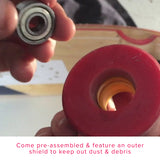 Person holding 608ZZ (608Z) ABEC-5 Shielded Scooter Wheel Bearings (Set of 2), showcasing the metallic, circular design and protective shields.