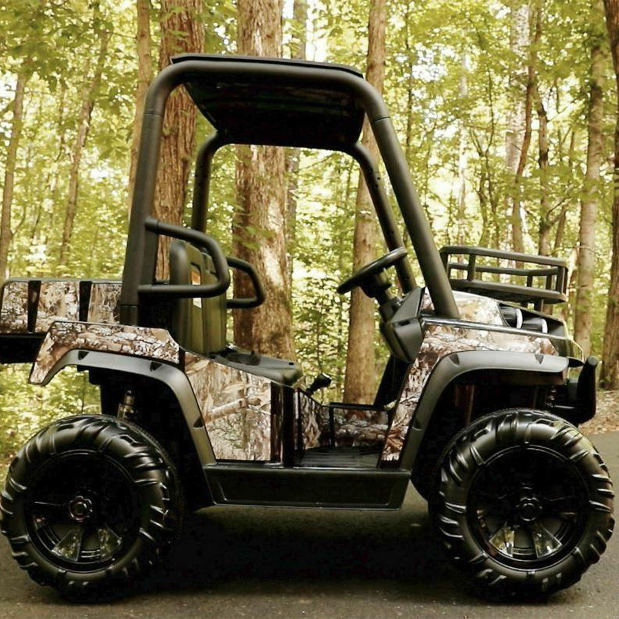 Replacement Battery Pack for the Realtree 24 Volt UTV Powered Ride-On, featuring two high-quality 12V batteries, shown beside a camouflaged off-road vehicle with visible tires and canopy.