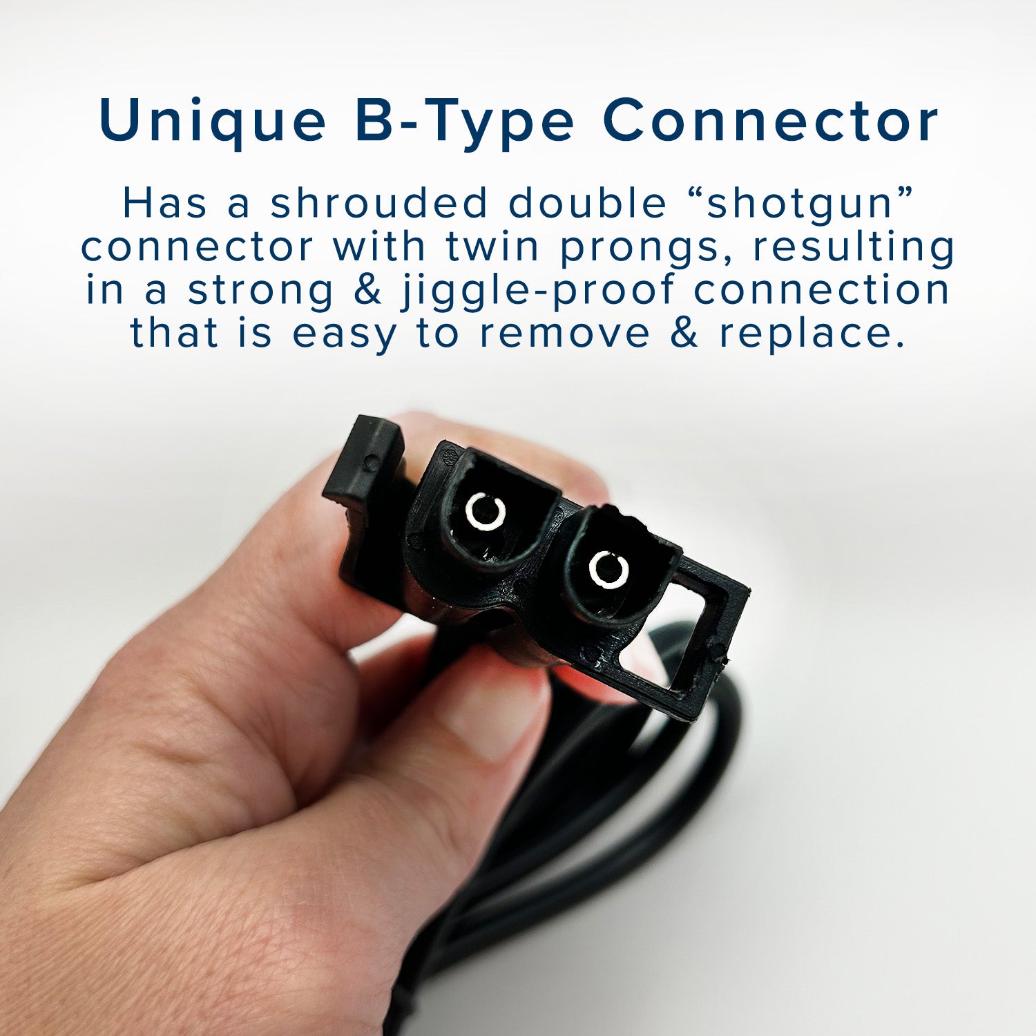 Hand holding the 12 Volt Battery Charger for Kids Ride-On Toys with B-Type Connector, showcasing its unique twin-prong design for secure and easy connection.