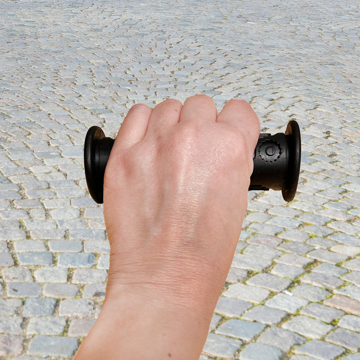 Hand holding a Handlebar Grip Set for the Razor Dirt Quad 500 (Version 1+), showcasing one full-length and one half-length grip.