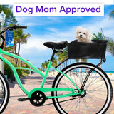 Market-Style Rear Basket for Bicycles (Axiom) attached to a bicycle's rear rack, holding a white fluffy dog. The durable, open-top wire mesh basket offers a 55 lb. carrying capacity.