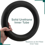 Hand holding a 12-1/2x2-1/4 SOLID (Flat-Free) Urethane Scooter & Power Chair Inner Tube Insert, ideal for replacing inner tubes in pneumatic tires.