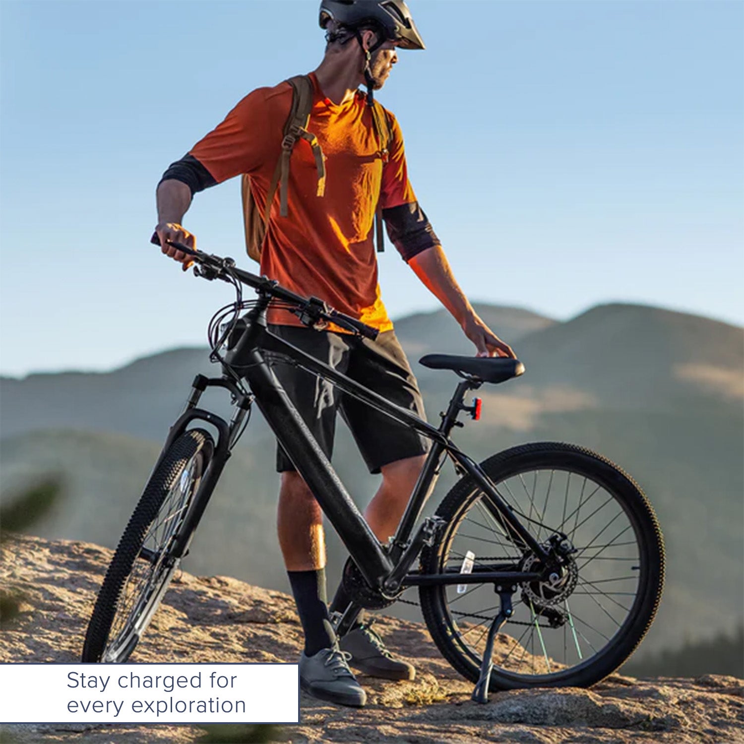 Man wearing a helmet and backpack standing with a bicycle, representing the 42 Volt Charger for Jetson® Bolt & Bolt Pro Electric Bicycles, essential for Lithium-ion batteries with RED/GREEN LED indicators.