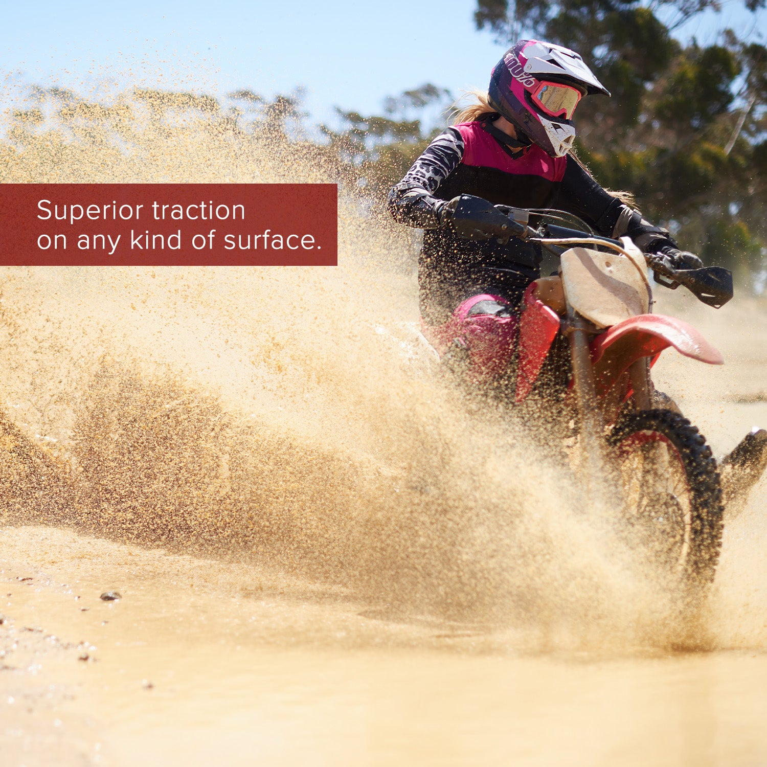 Person riding a dirt bike equipped with the 90/100-16 Dirt Bike Tire with QD015 Knobby Tread, showcasing its aggressive tread pattern ideal for off-road and muddy conditions.