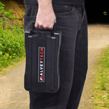 A person holding a 24 Volt Rack Mount Battery Pack for Currie Electric Bikes, featuring a black plastic case with red text, designed for eZip and IZIP bikes.