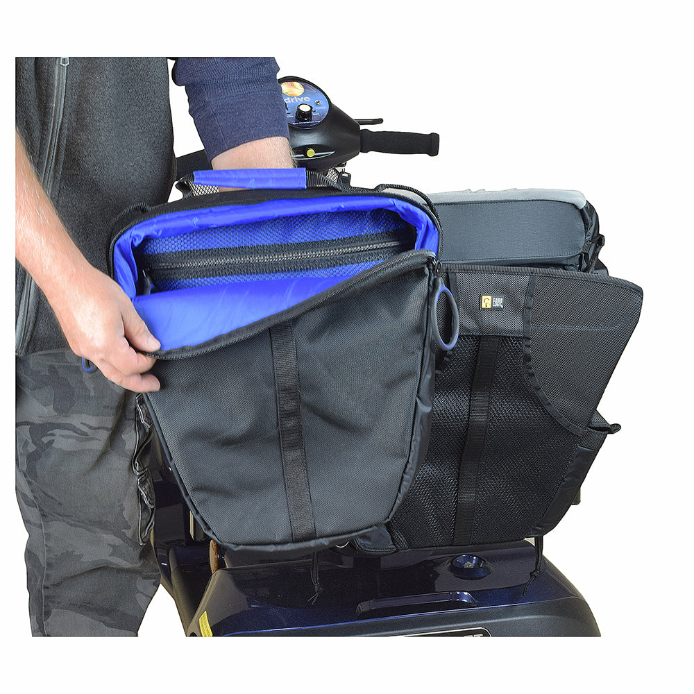 Person holding the sleek black nylon Backpack for Mobility Scooters and Power Chairs by Case Logic, showing large zipper pulls and accessible storage compartments, ideal for users with limited range of motion.