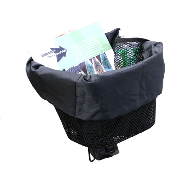 Basket Carry Tote for Mobility Scooters pictured inside a scooter basket with a drawstring closure, a book, and a bag, highlighting its compatibility and durable, easy-to-clean nylon material.