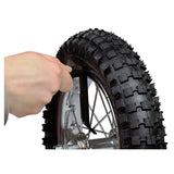 A hand holding a plastic tire lever, ideal for bike and scooter tire maintenance, showcasing its curved spoon end for easy tire removal and spoke hook for secure bead separation.