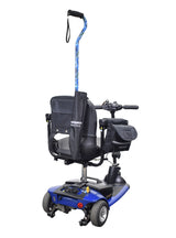 Universal Cane Holder & Saddle Bag Combination for Mobility Scooters, Power Chairs, & Wheelchairs; features a black handle, blue scooter, and attached black nylon saddle bag with multiple compartments.