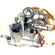 Close-up of a 20/20 oil-injected carburetor (LF/SI) for Vespa VNX, VLX, and VSD scooters, showing intricate metal gears and levers essential for vintage Vespa engine performance.