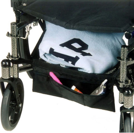 Cargo Shelf for Wheelchairs shown below the seat, demonstrated with a folded towel on it, attached to a wheelchair with visible wheels.