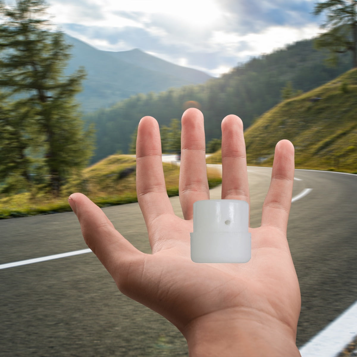 Hand holding the Plastic Tip for the Stabilizing Post on the Razor Crazy Cart (Versions 1+), shown close-up against an outdoor background featuring a road and trees.