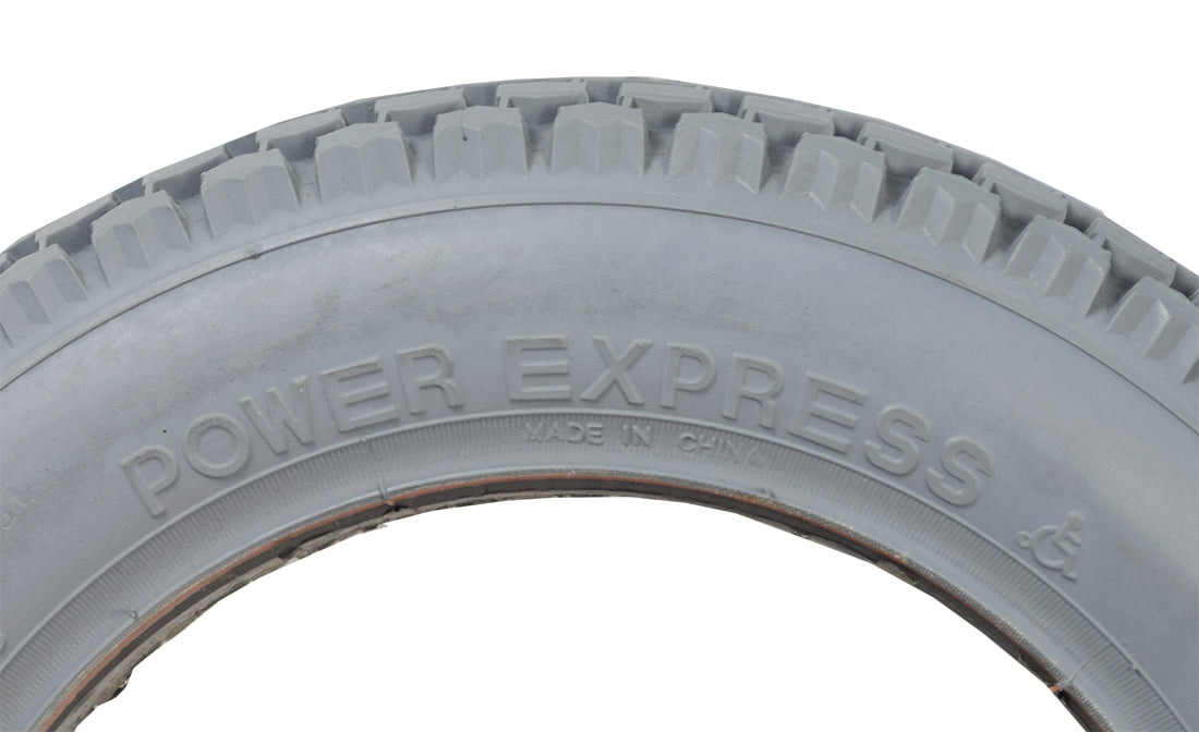 Close-up of the 12-1/2x2-1/4 Foam-Filled Mobility Tire with C628 Knobby Tread, showcasing its detailed tread pattern and solid, non-marking gray rubber design, ideal for mobility scooters and power chairs.