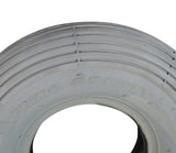 Close-up of 2.80/2.50-4 (9x3) Pneumatic Mobility Tire with C179G Spirit Ribbed Tread, highlighting its non-marking gray rubber and detailed ribbed pattern, ideal for indoor and outdoor use.