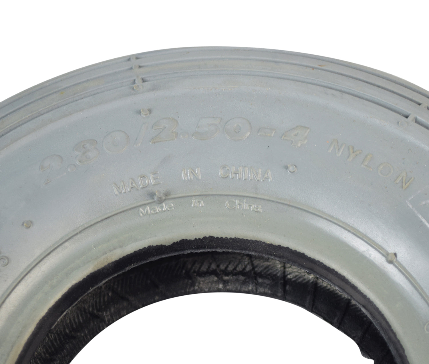 Close-up of the 2.80/2.50-4 (9x3) Pneumatic Mobility Tire with C179G Spirit Ribbed Tread, showcasing its detailed ribbed pattern and smooth, non-marking gray rubber surface.