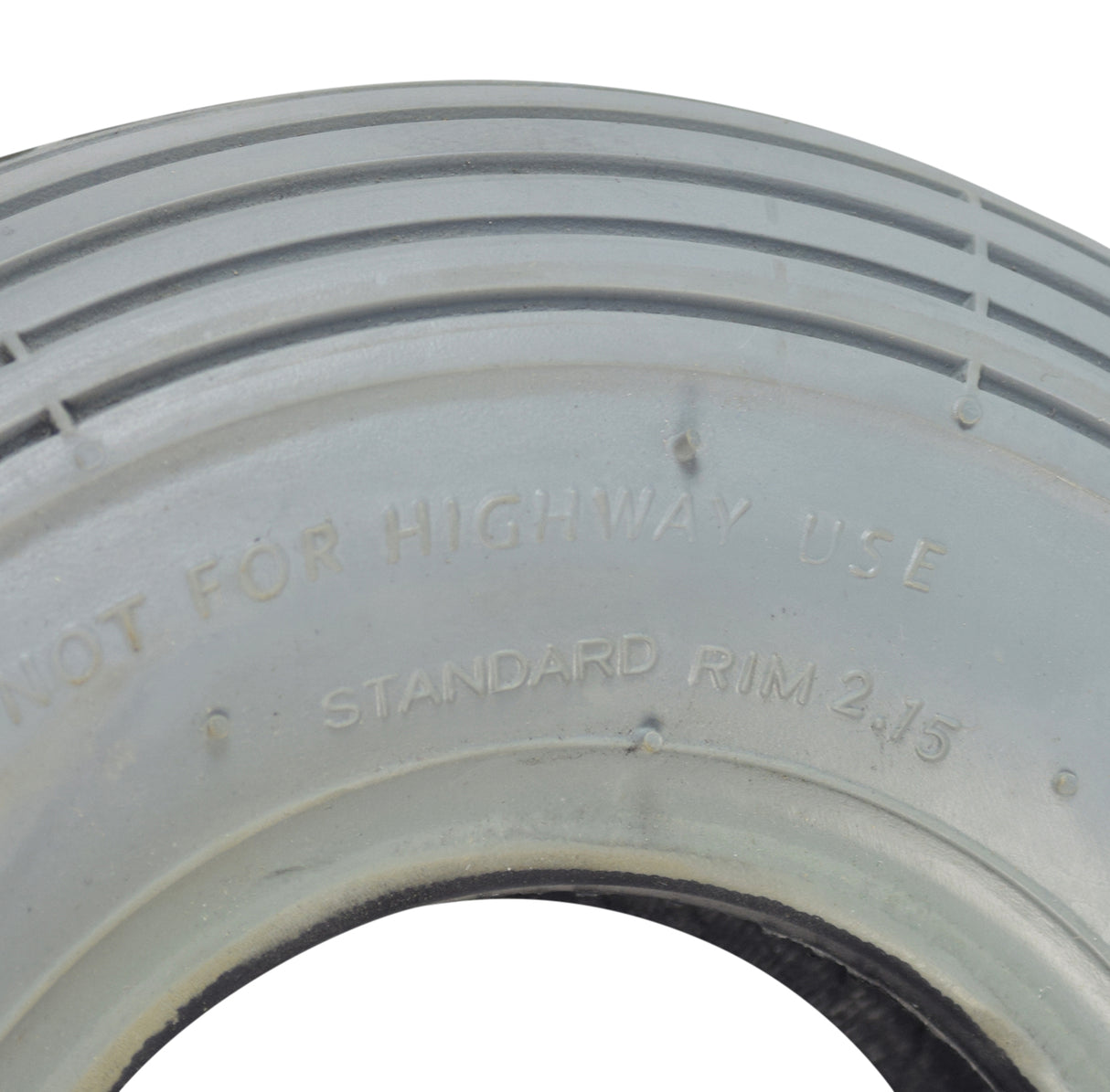 Close-up of the 2.80/2.50-4 (9x3) Pneumatic Mobility Tire with C179G Spirit Ribbed Tread, showcasing its detailed ribbed pattern and sturdy build designed for enhanced maneuverability on mobility devices.