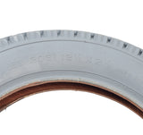 Close-up of the 12-1/2x2-1/4 Pneumatic Mobility Tire with C628 Power Express Tread, highlighting its knobby tread pattern and durable gray rubber construction.