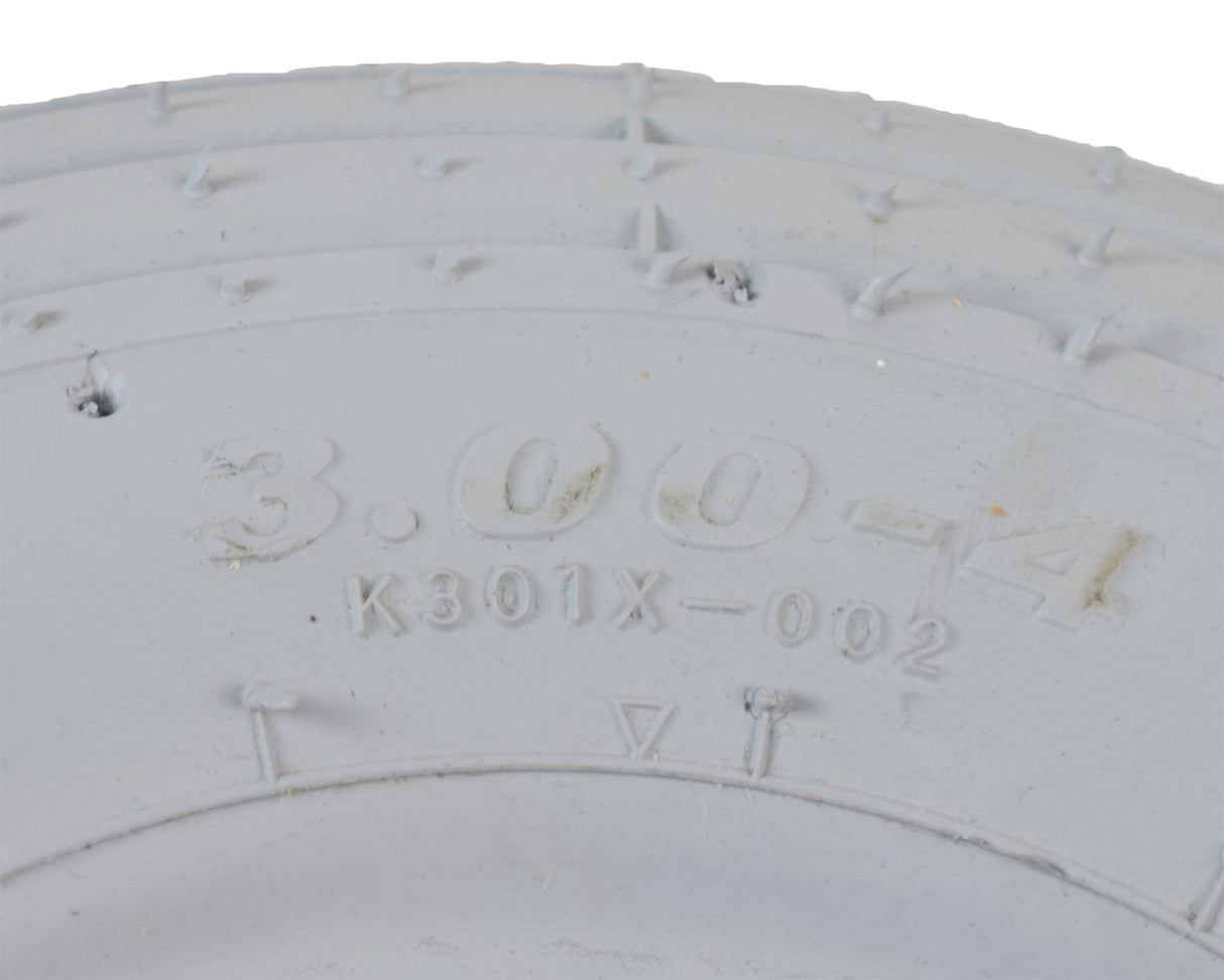 Close-up of the 3.00-4 (10x3, 260X85) Foam-Filled Mobility Tire with K301 Ribbed Tread, showing detailed tread pattern and robust construction, ideal for front use on mobility scooters and power chairs.